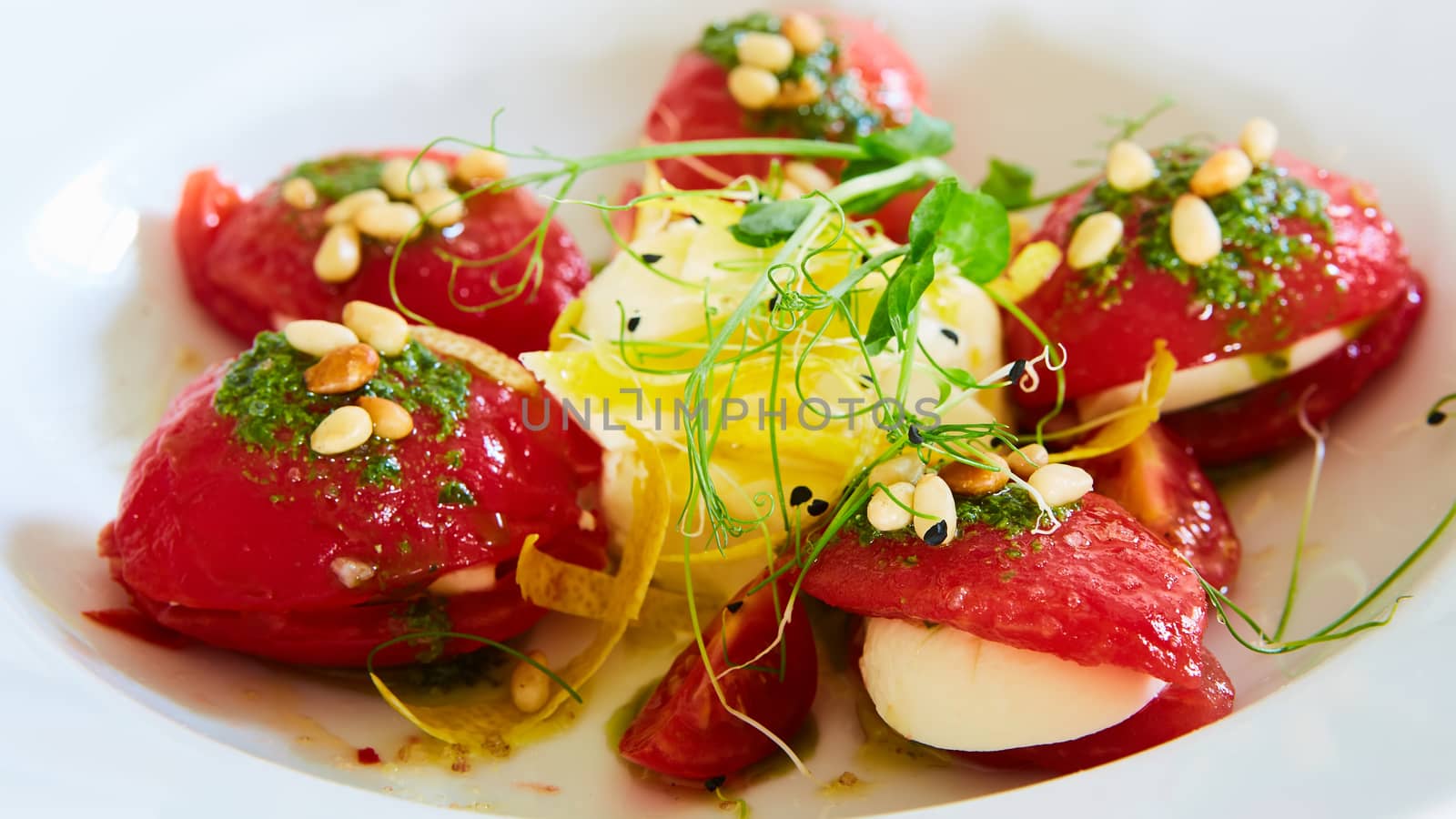 Mozzarella and tomato salad - caprese on the white plate. Shallow dof.