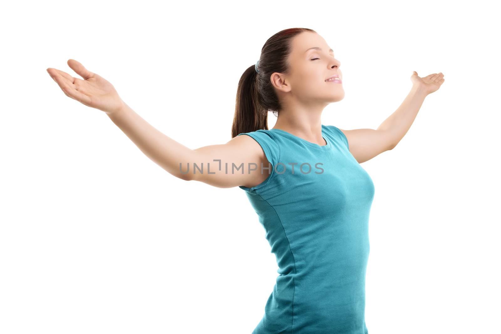 Beautiful young girl with outstretched arms, feeling calm, smiling and looking upward, isolated on white background.