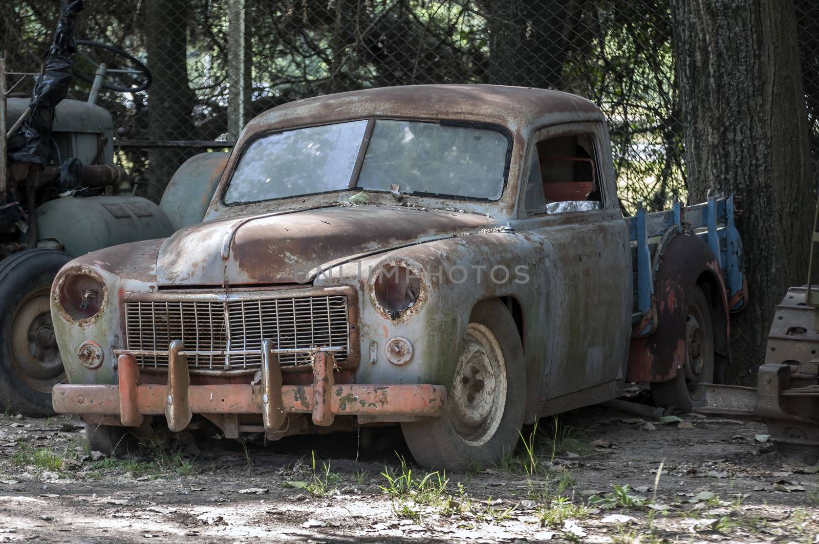 Stock image of an old, rusted, abandoned car.