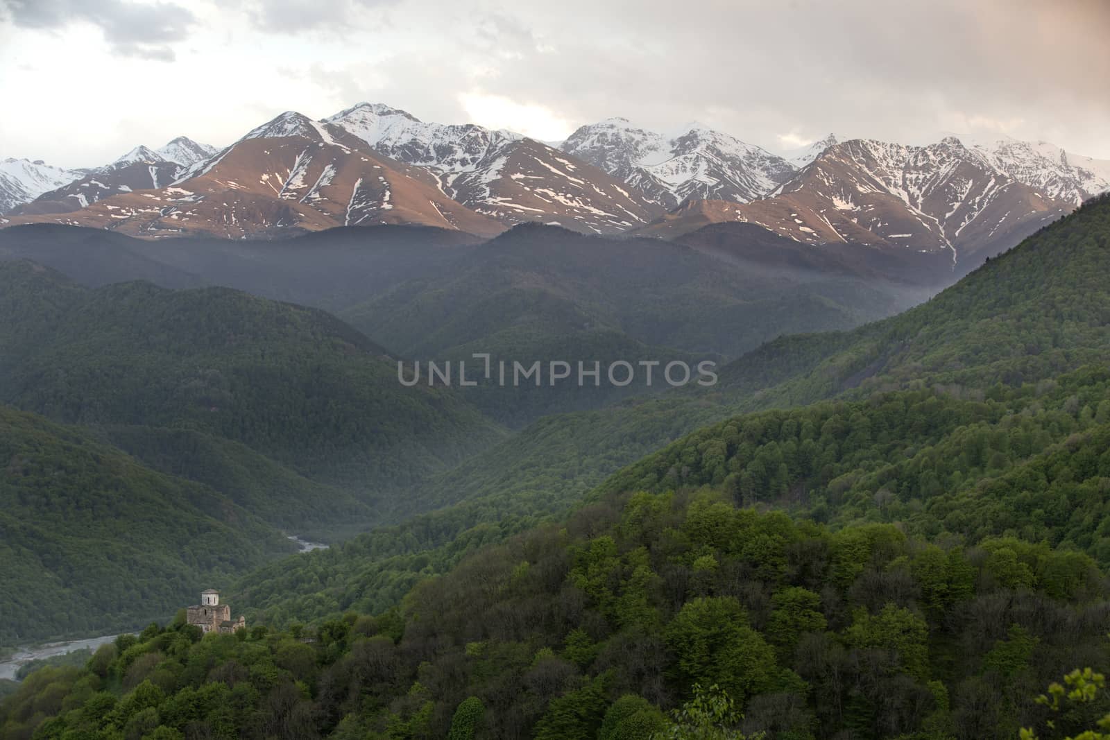 Church of the 10 century between mountains covered with forest, Russia, Caucasus.
