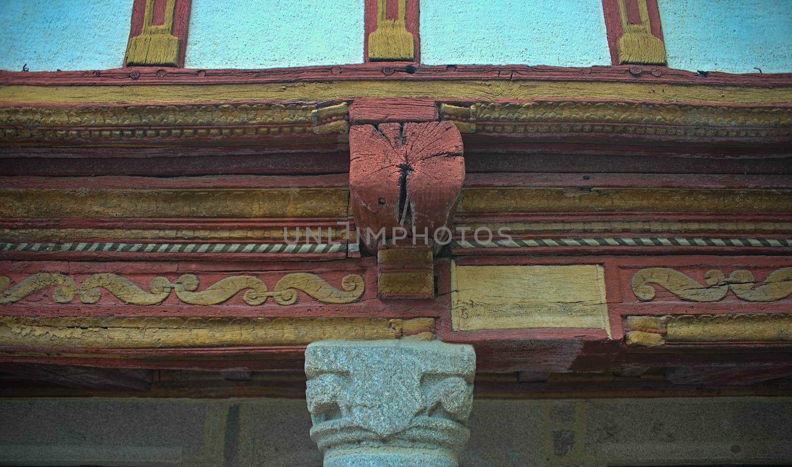 Wooden beam with decorations on old medieval building