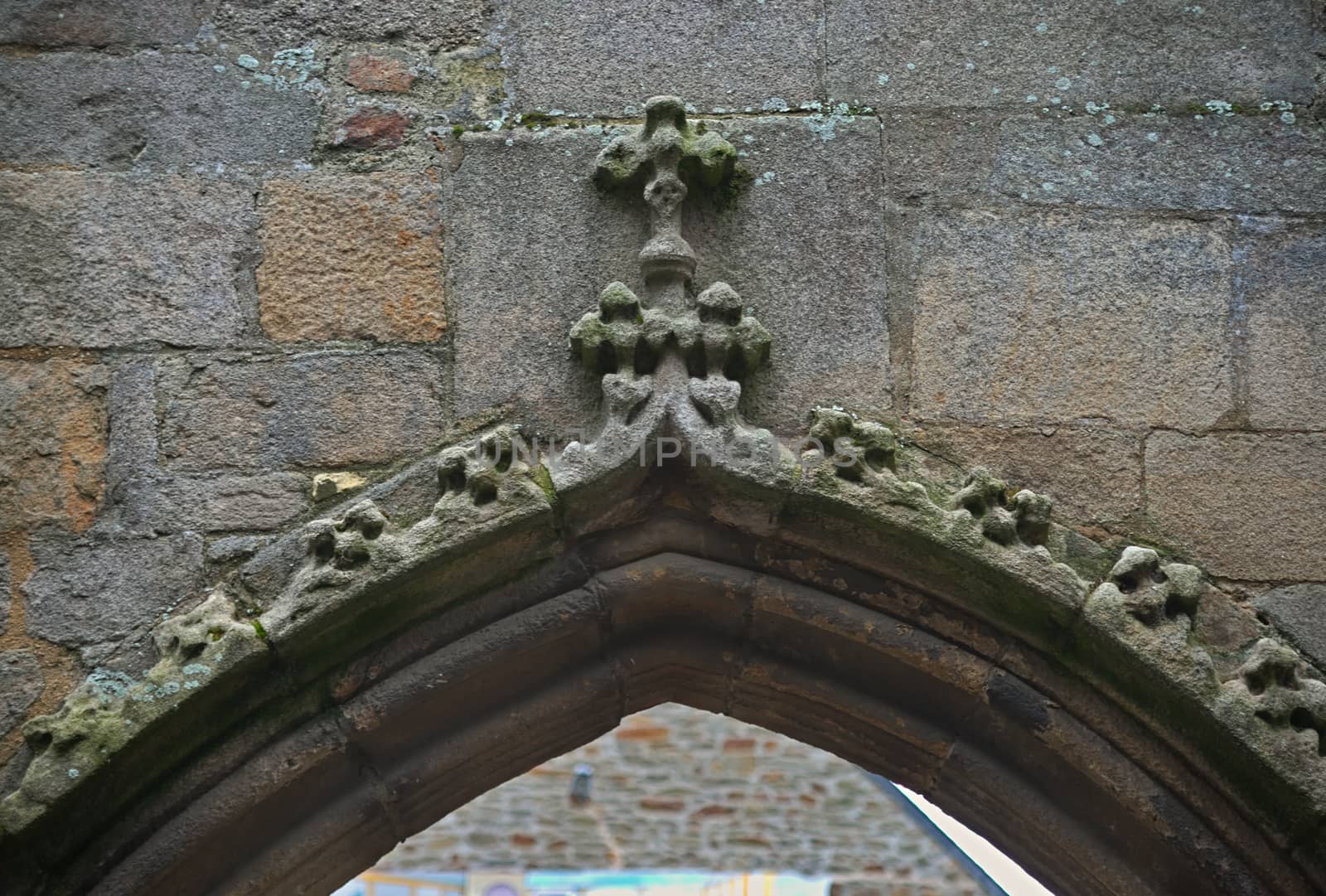 Upper part of stone archway with cross on the middle by sheriffkule