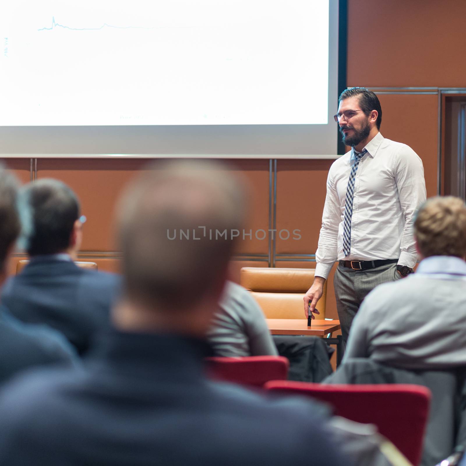 Speaker Giving a Talk at Business Meeting. Audience in the conference hall. Business and Entrepreneurship concept.