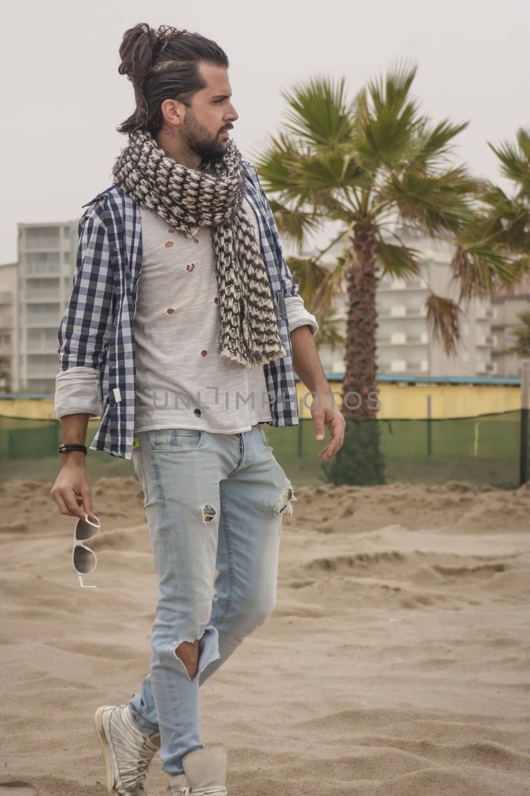 Fashion boy posing for a shooting at park