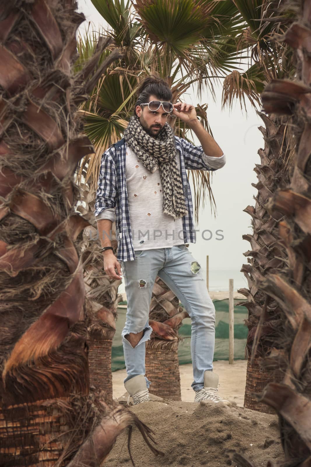 Fashion boy posing for a shooting at park