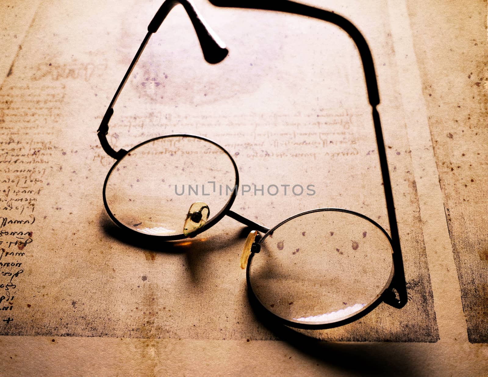 Close up of old classic spectacles on a book background