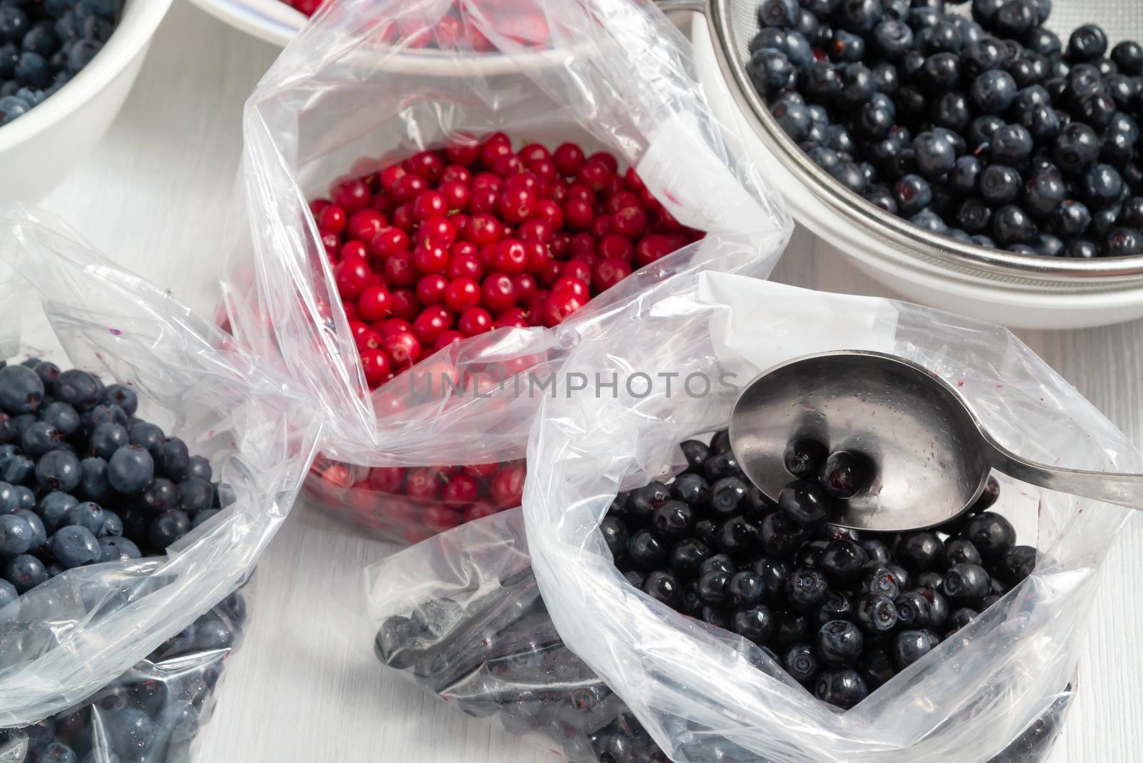 Process of preparing berries for freezing - folding into packages.