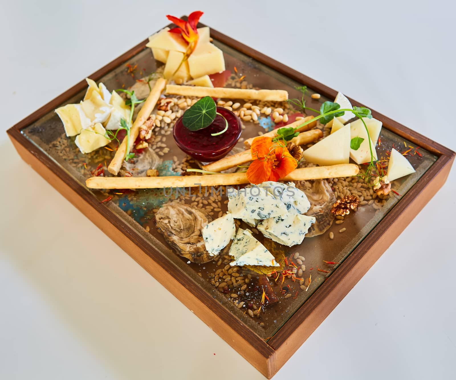 Cheese selection on wooden rustic board. Cheese platter with different cheeses on wood