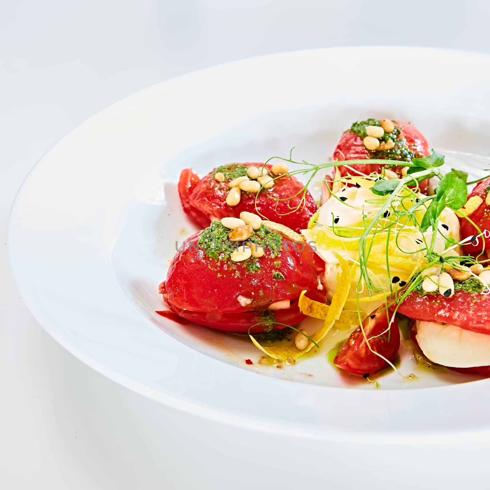 Mozzarella and tomato salad - caprese on the white plate. Shallow dof.