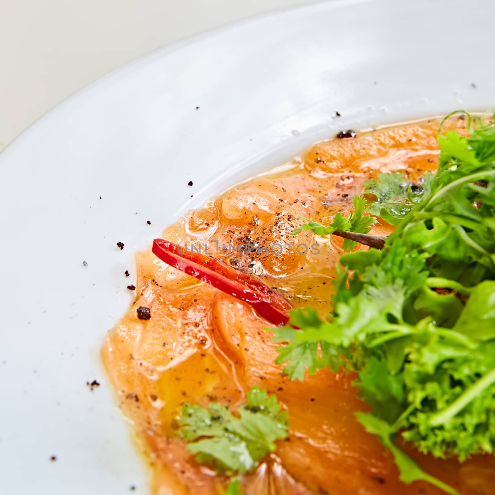 Top view of salmon carpaccio. Shallow dof. by sarymsakov