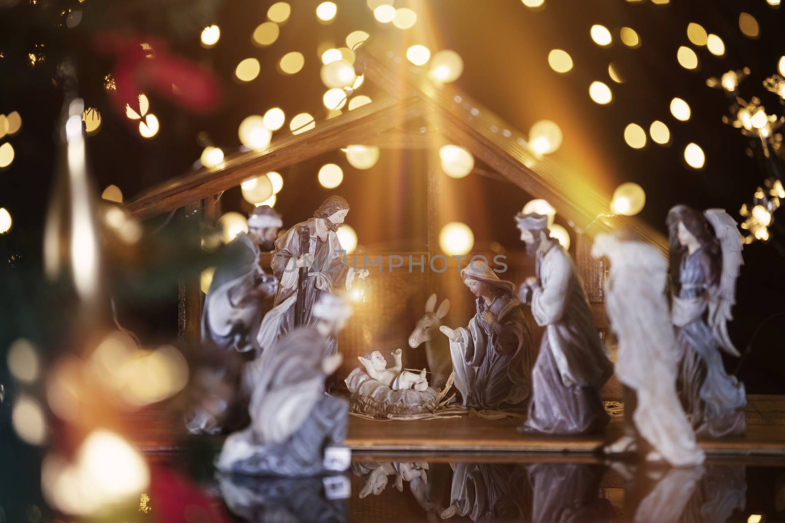 Christmas Manger scene with figurines including Jesus, Mary, Joseph, sheep and wise men. Focus on baby!