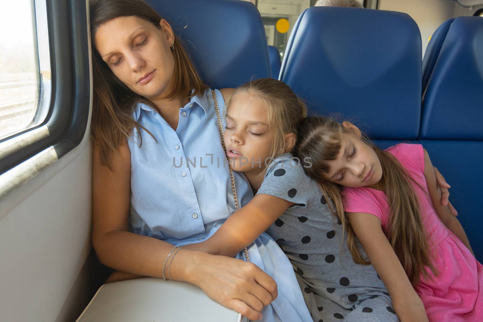 Mom and two daughters fell asleep in an electric train car by Madhourse