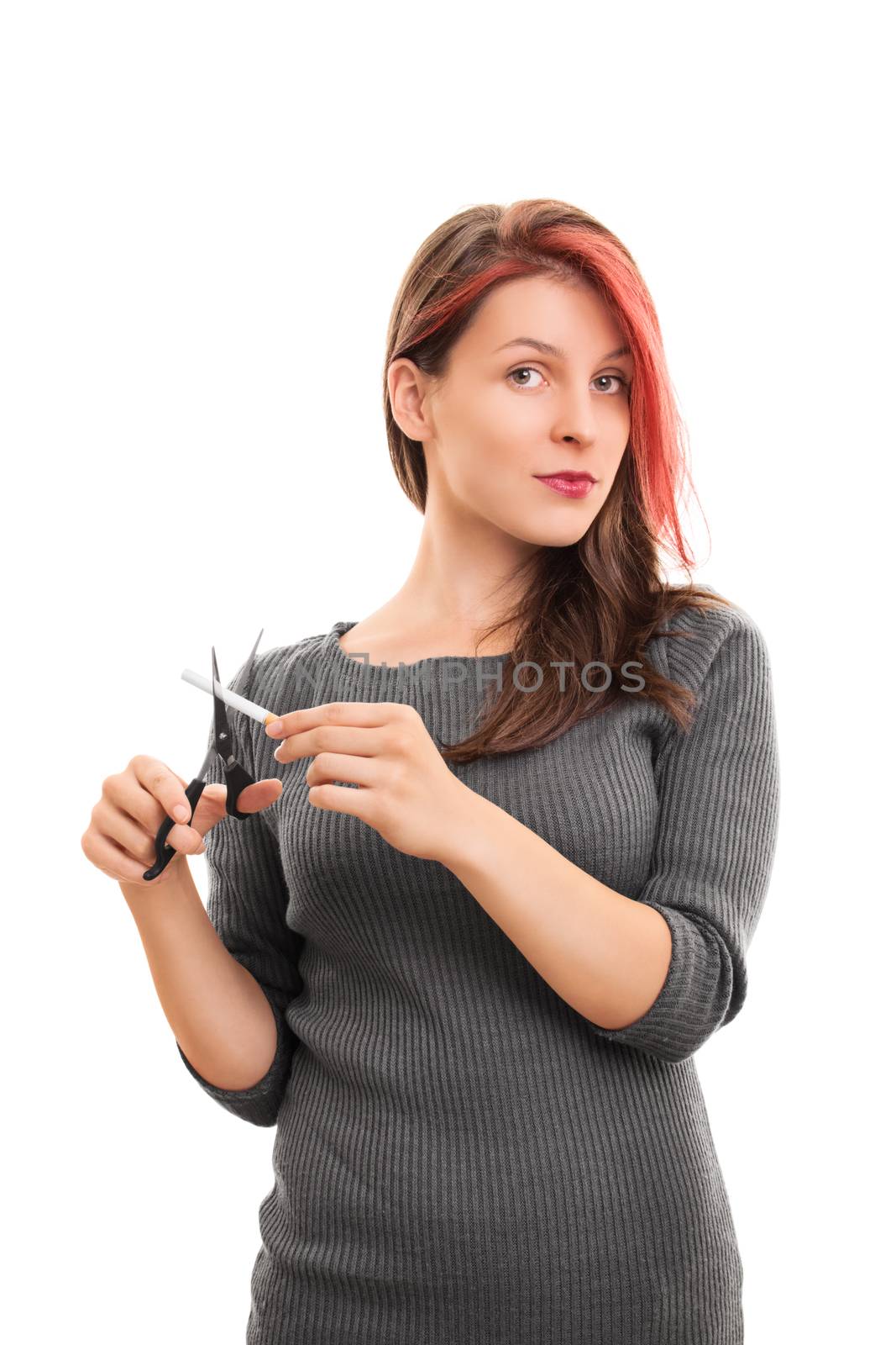 Stop this bad habit! Beautiful young girl cutting a cigarette with scissors, isolated on white background.