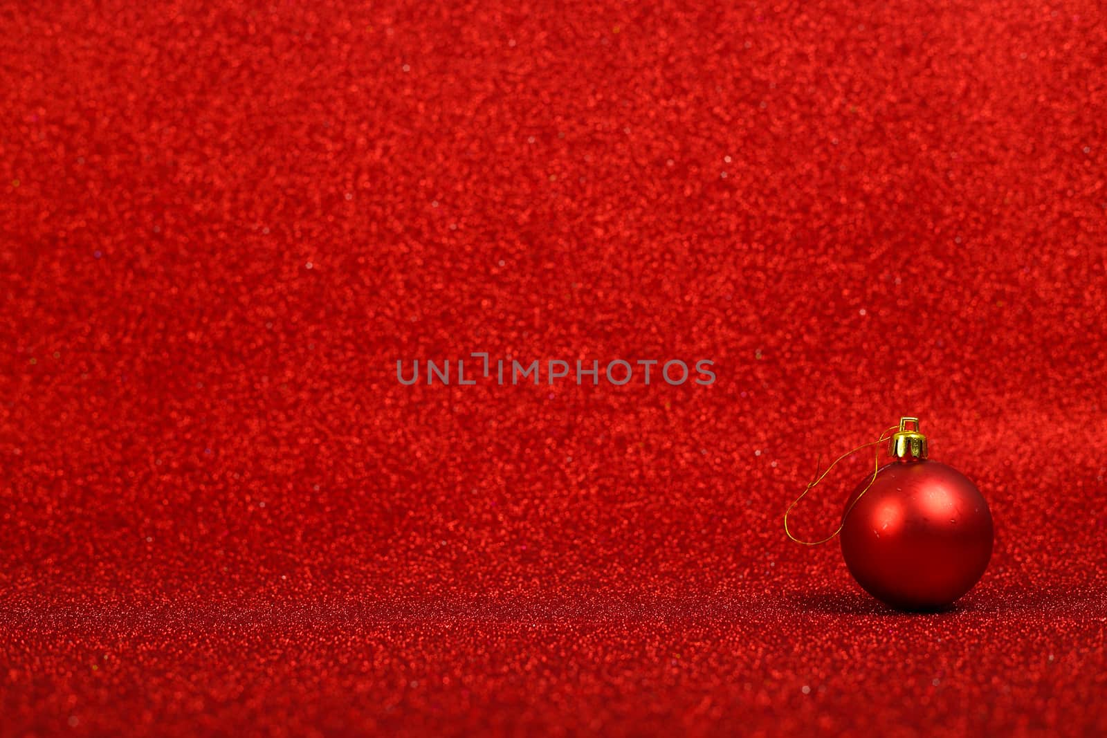 Christmas or new year decor of bauble on abstract red light background