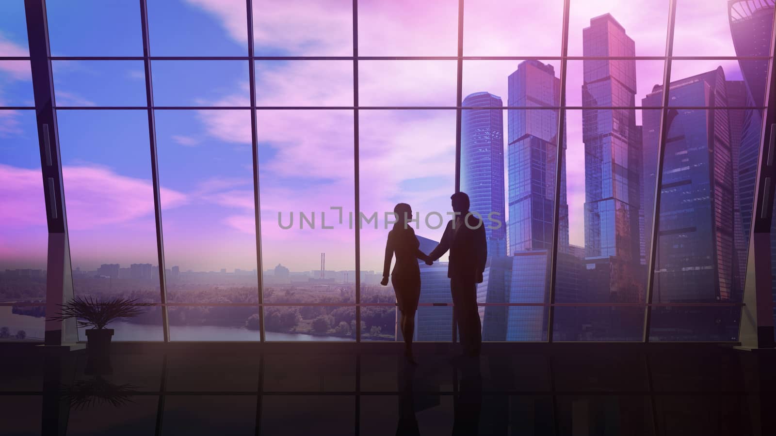 Male and female silhouette shake hands on a sunset background while standing in their office with a view of skyscrapers.