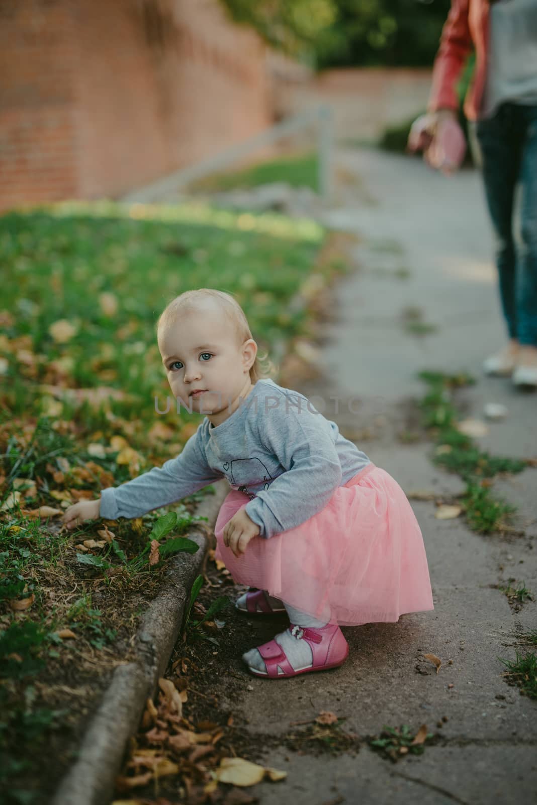 Adorable girl having fun on beautiful autumn day. authentic childhood image