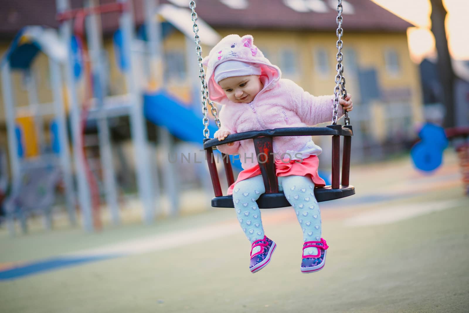 Little girl spending fantastic time on playground. Happy childhood. Authentic image