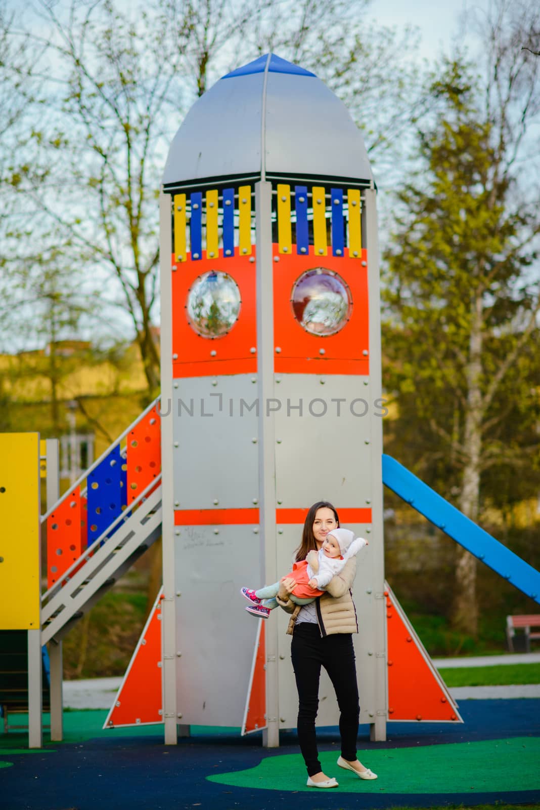 Happy mother and daughter in the park. Beauty nature scene with  by Brejeq