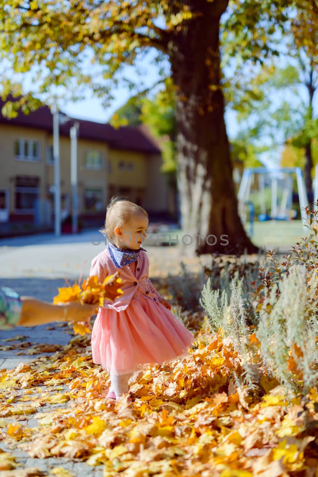 Adorable girl having fun on beautiful autumn day. authentic childhood image