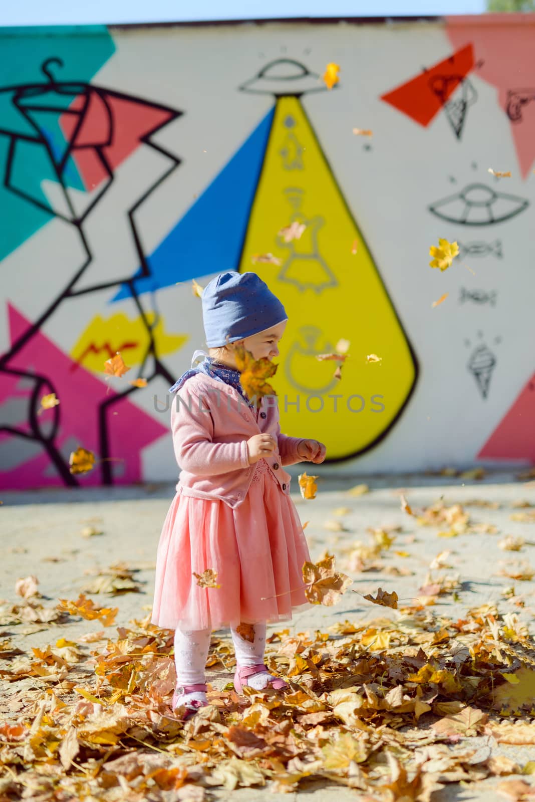 Adorable girl having fun on beautiful autumn day. authentic childhood image