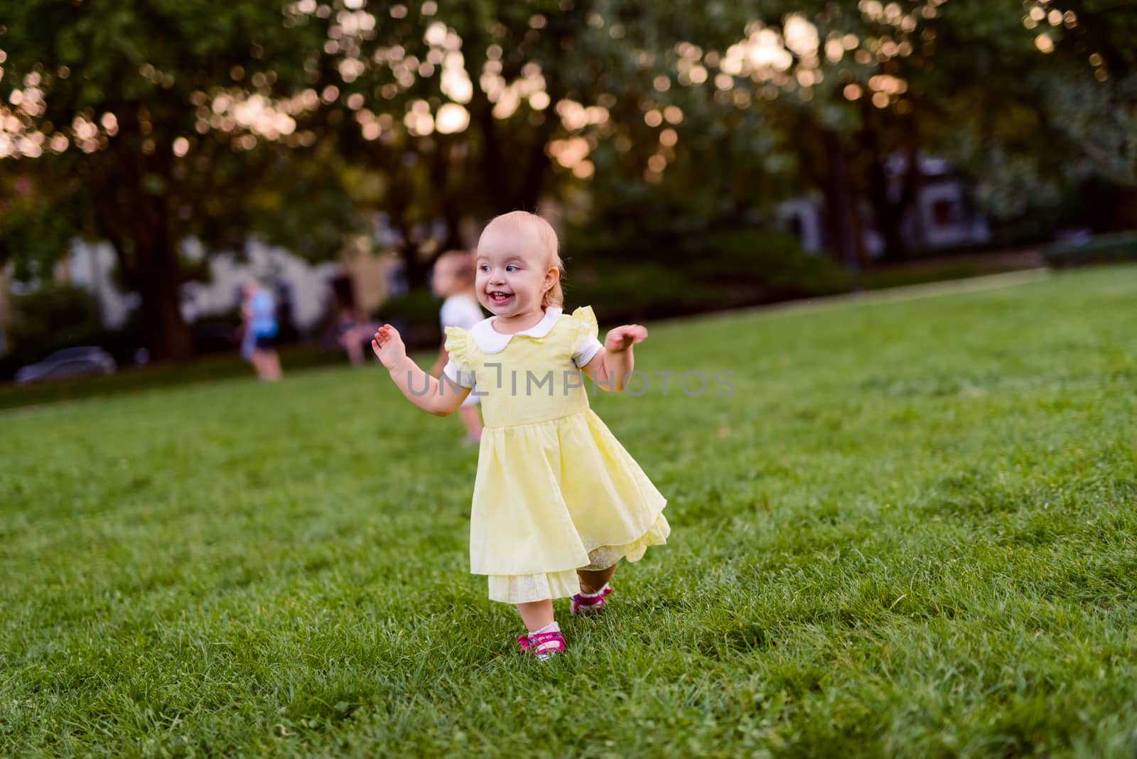Smiling girl on the meadow looking right at camera. authentic image