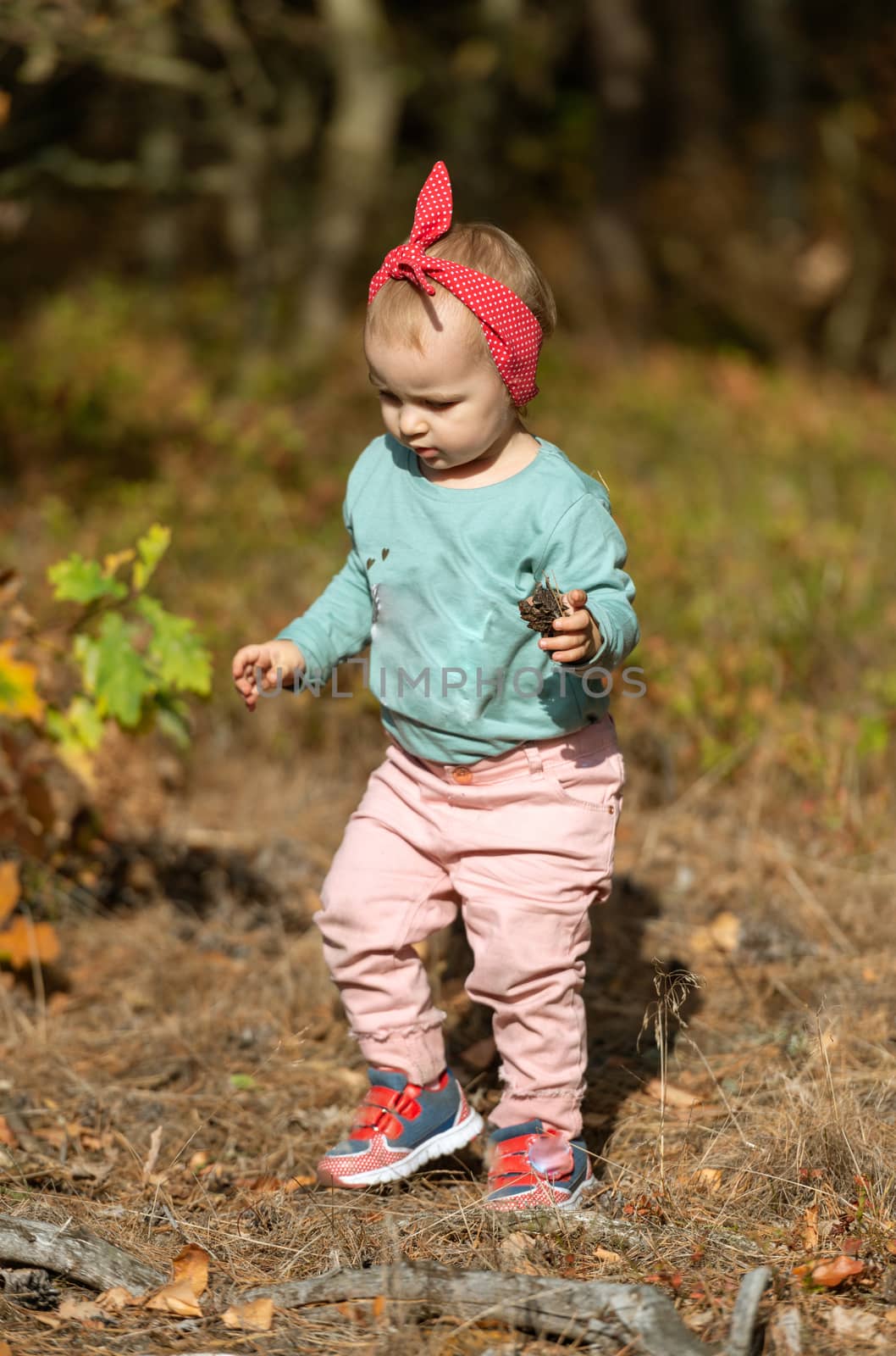 Adorable girl having fun on beautiful autumn day. authentic childhood image