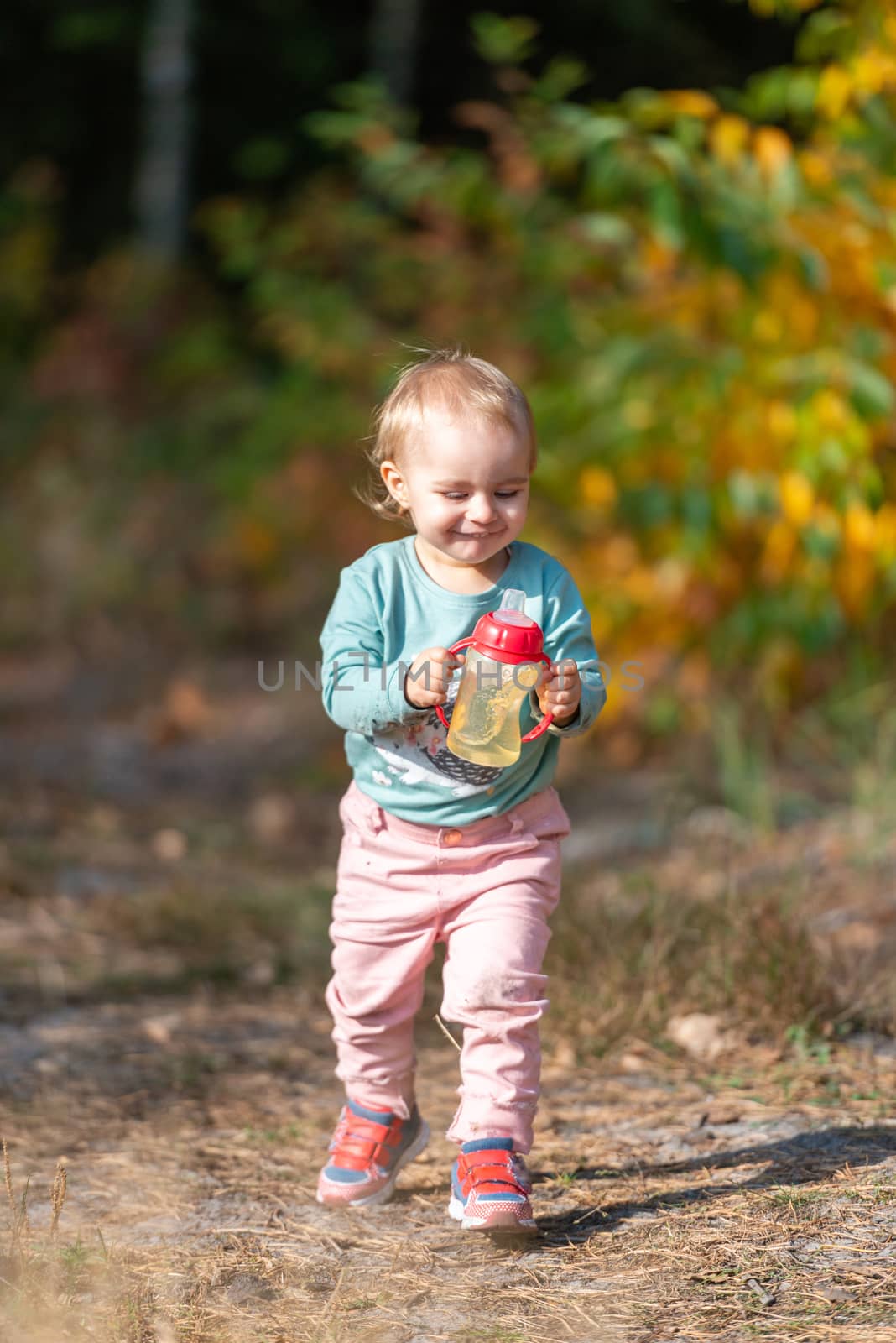 Adorable girl having fun on beautiful autumn day. authentic childhood image