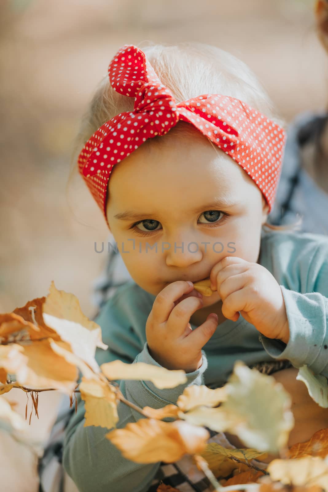 Adorable girl having fun on beautiful autumn day. authentic childhood image