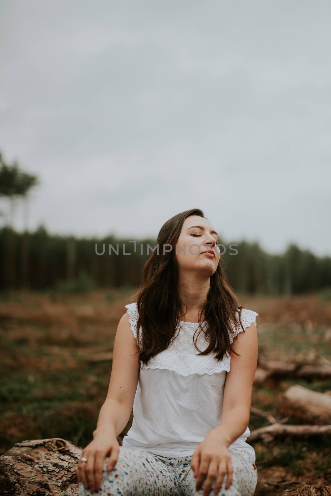 a photo of woman in the forest where the purple heather blooms. copy space. authentic image. by Brejeq