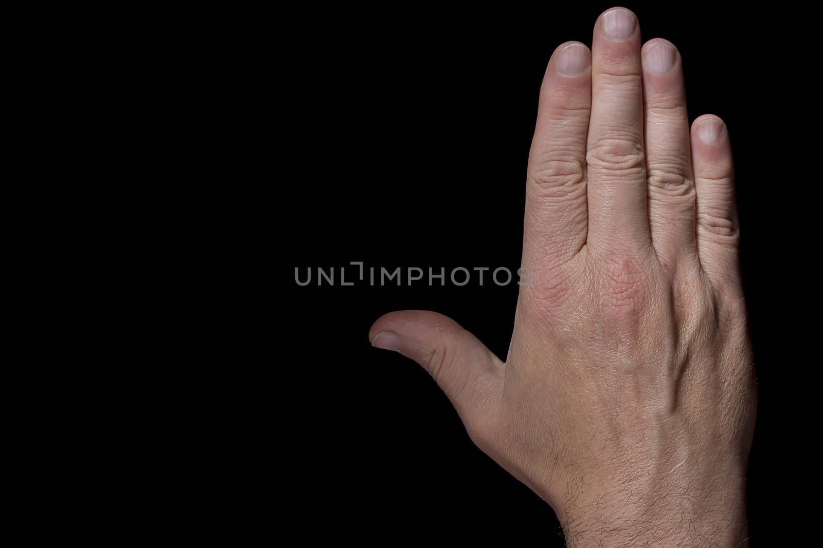 Male hand in a welcome gesture on a black background
