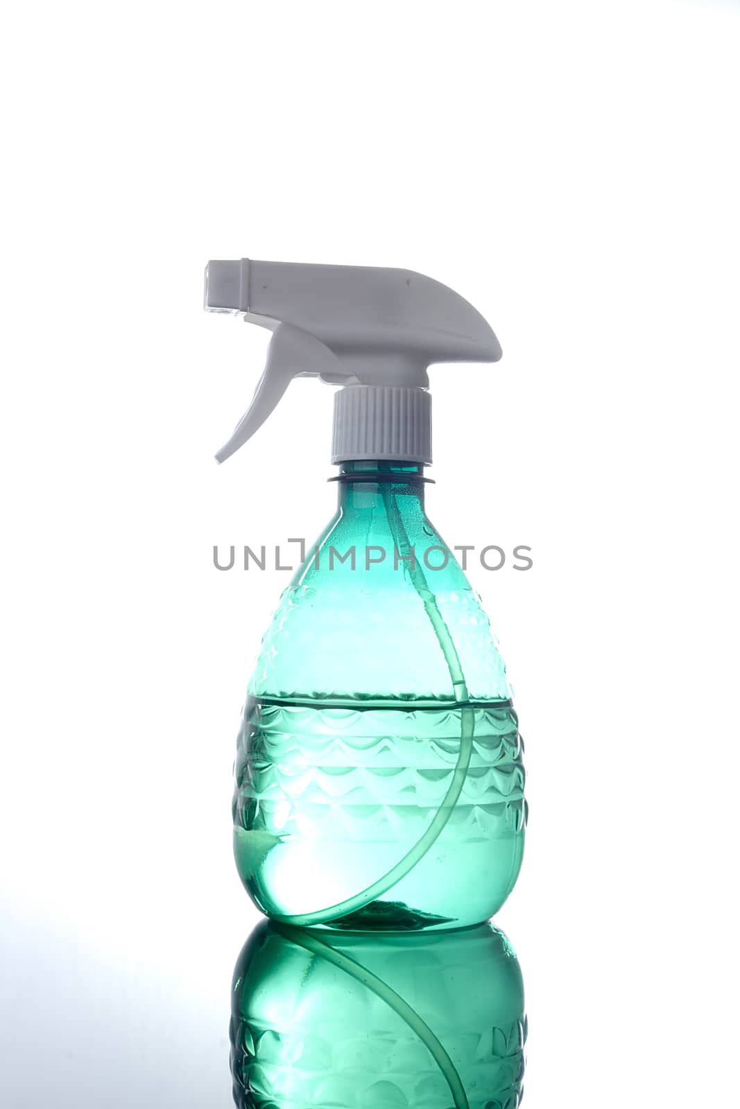 Blue plastic spray bottle on reflective surface