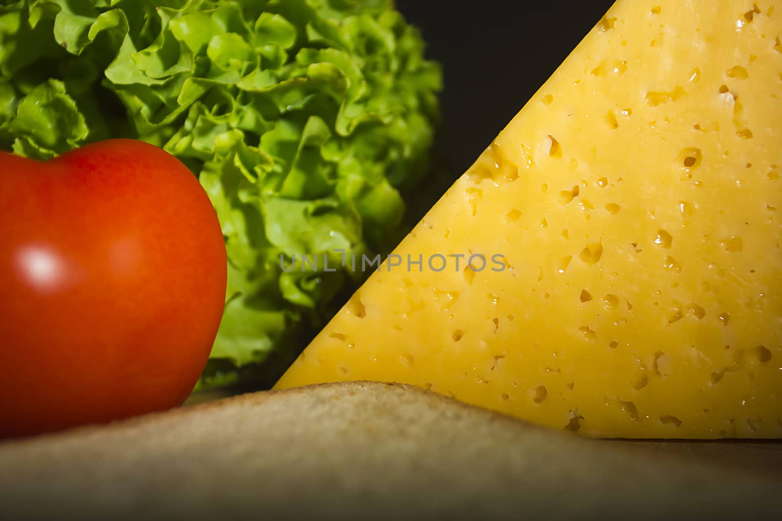 Sandwich bread, cheese and vegetables on the table