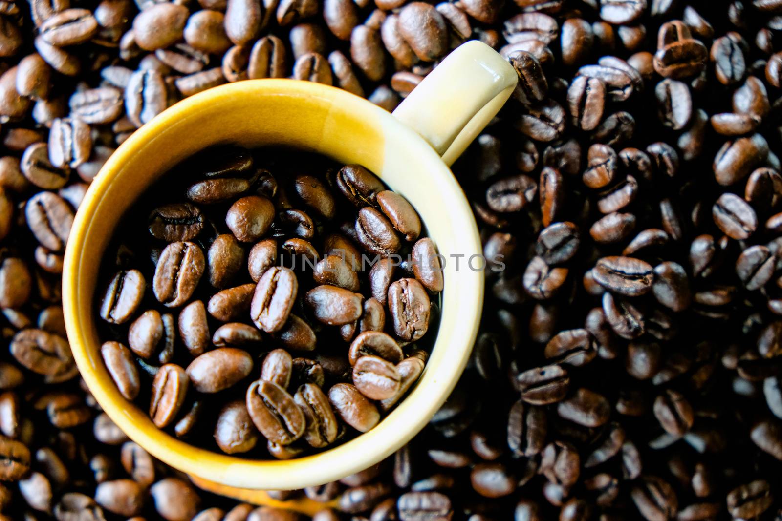 Cup of coffee with coffee beans