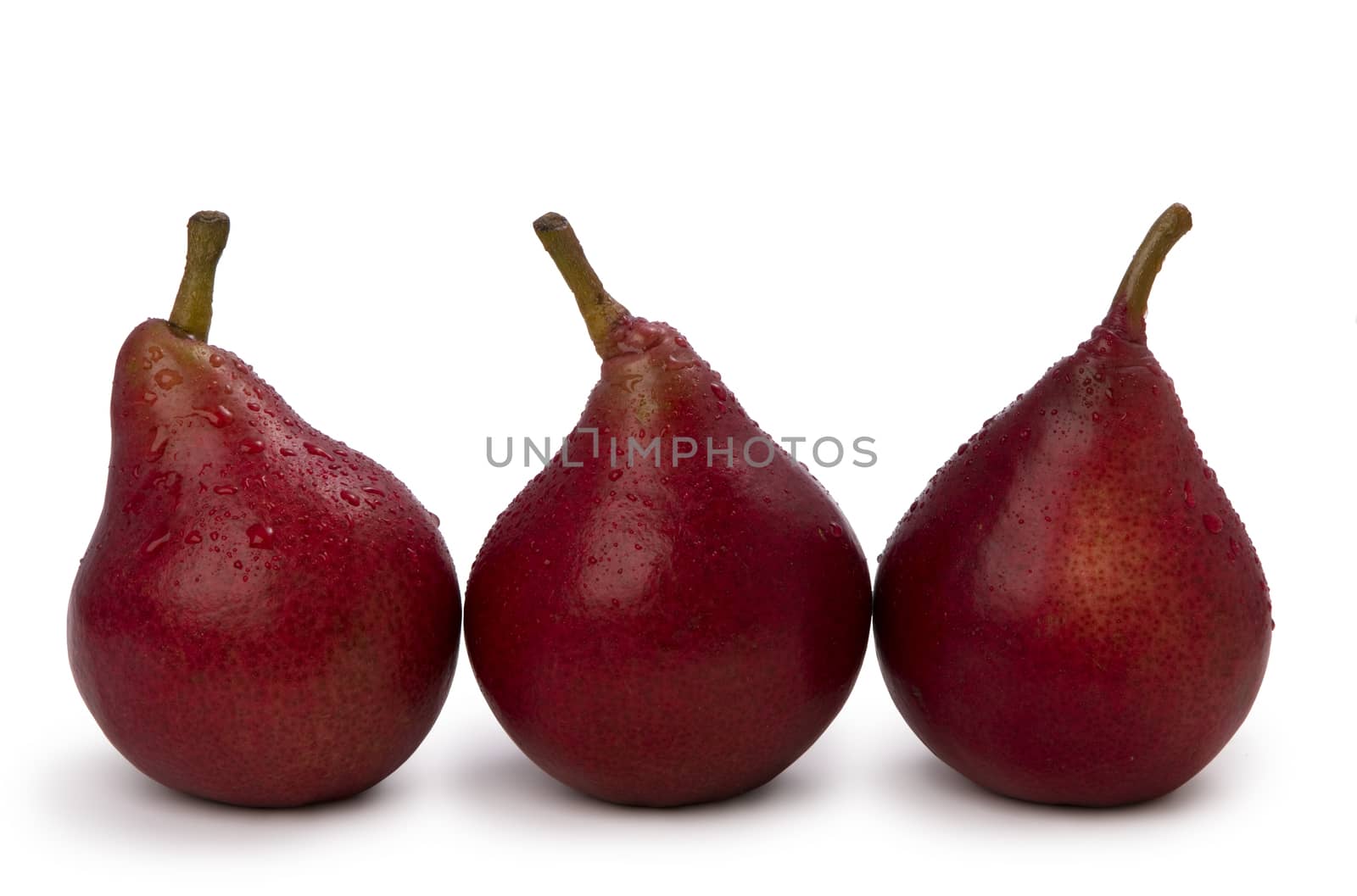  three red pears isolated on white background with water drops