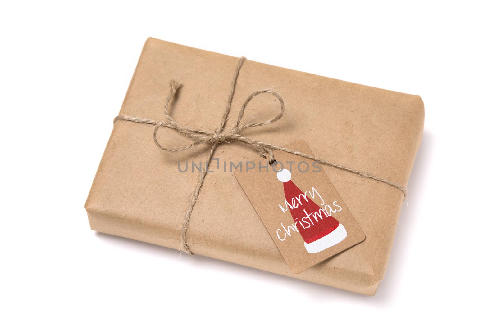 Christmas gift box wrapped in kraft paper. Isolated on white background
