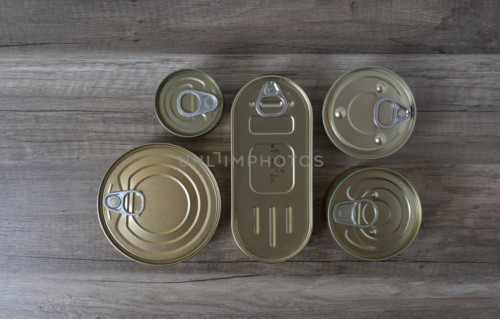 Tin cans for food on wooden background. Top View.