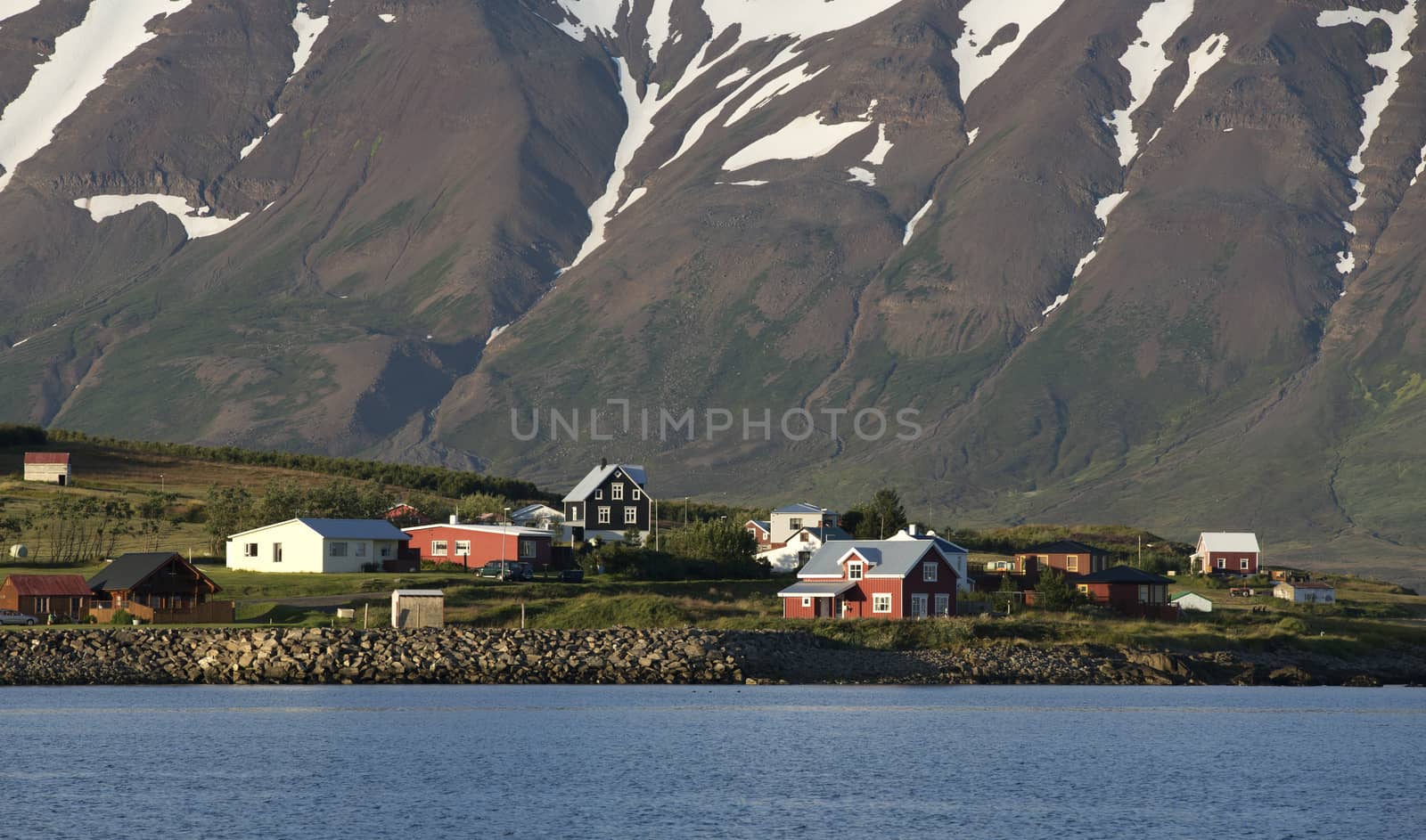 Typical icelandic landscape with volcanoes and houses.
