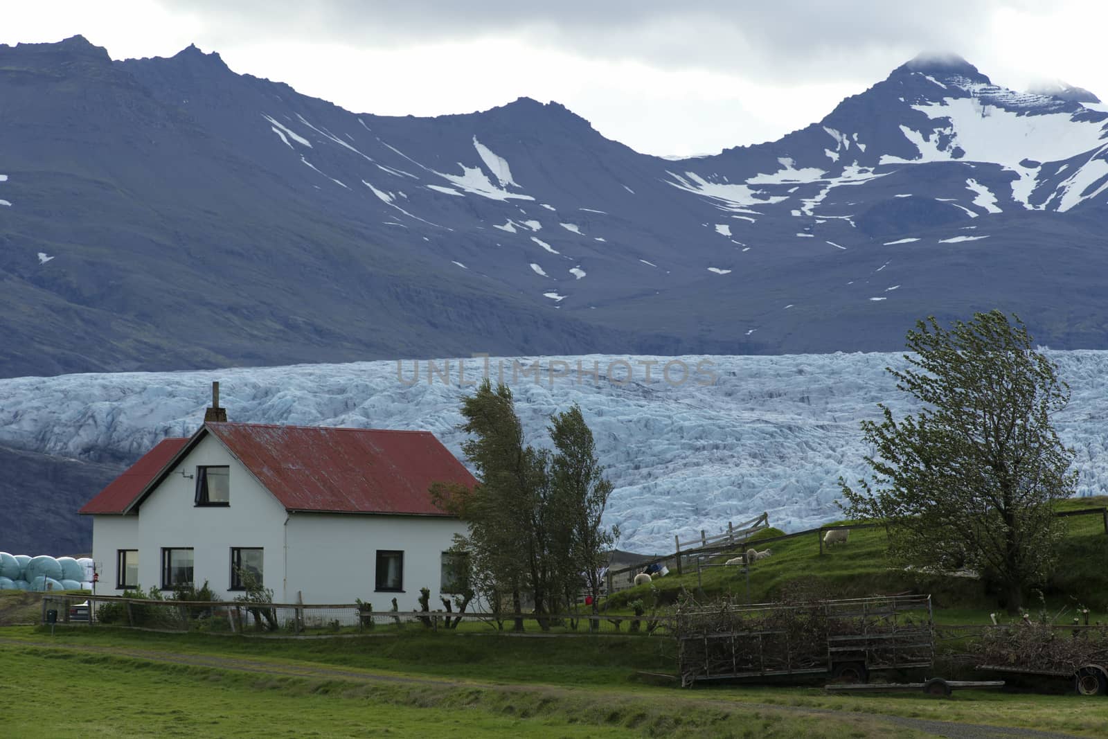 Icelandic House at the Bottom of Mountain and Glacier