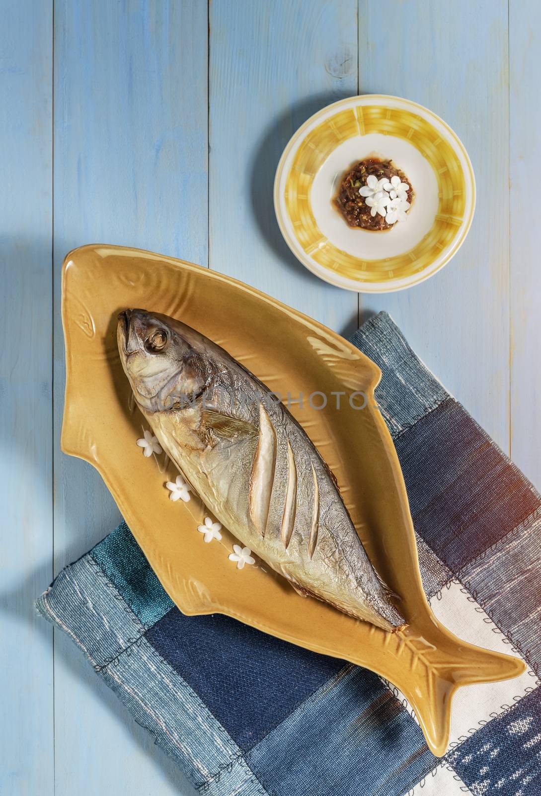 top view of fish dish over wooden background