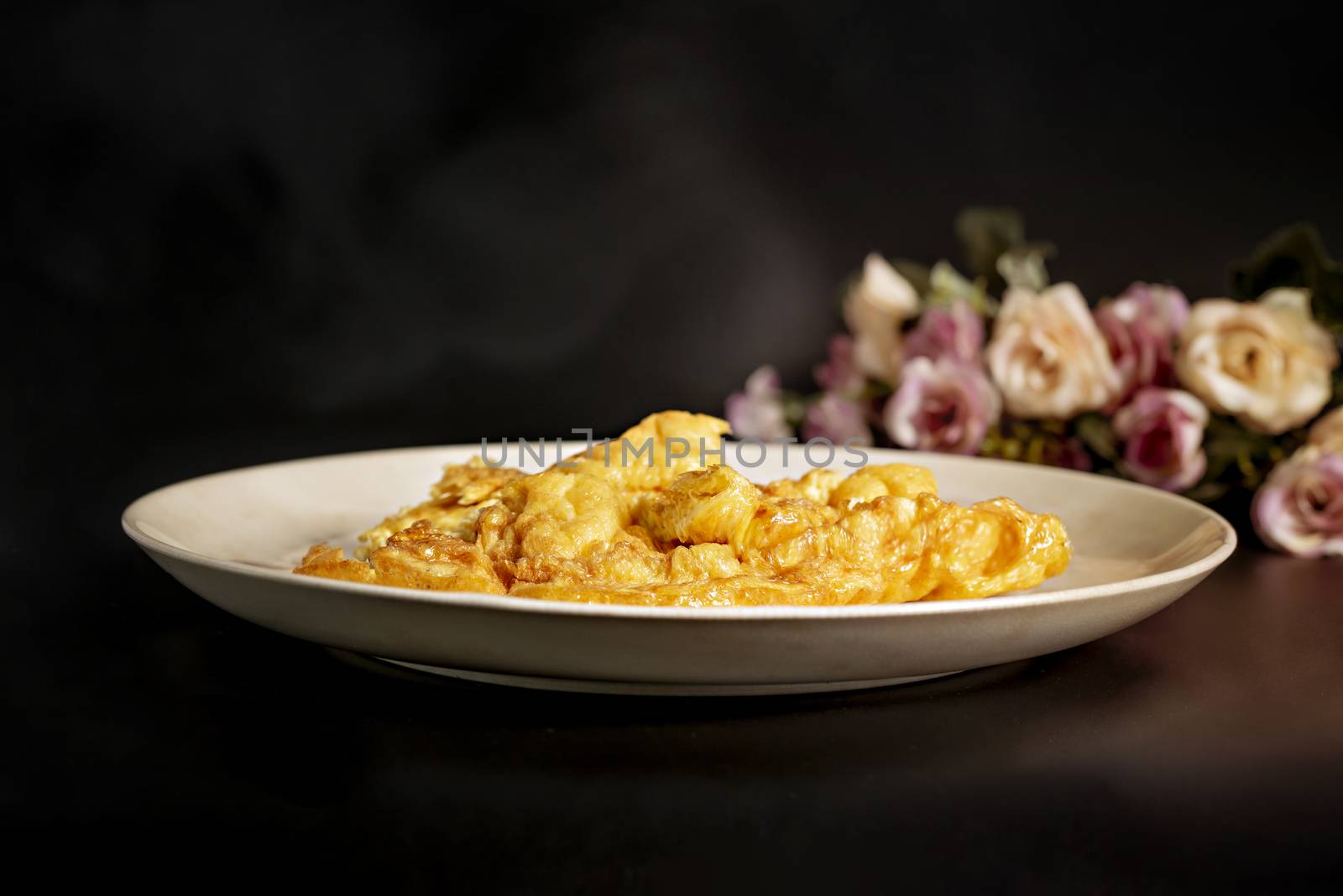 Thai omelette  or scrambled eggs  on white dish