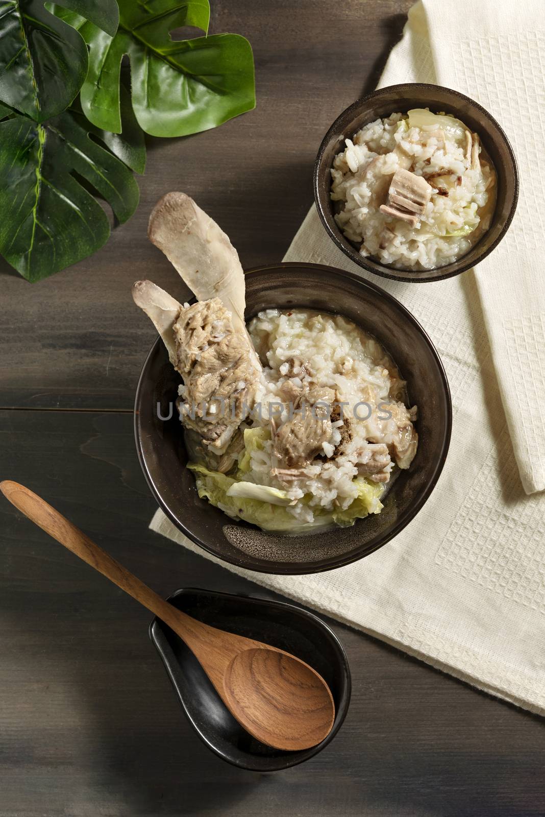 Top view of asian style rice soup with pork in a bowl