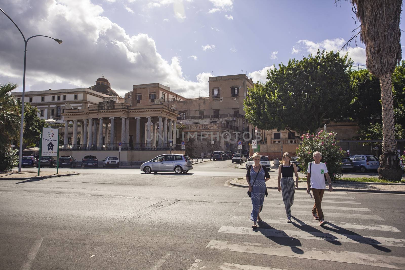 View of the people crossing the zebra lines on the road in front of the Foro Italico in Palermo