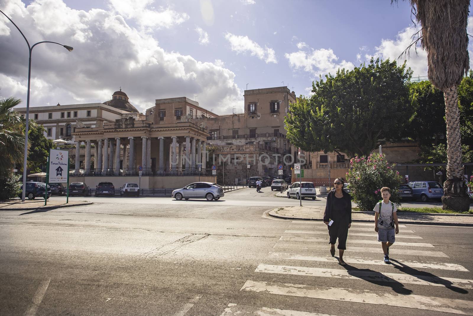 View of the people crossing the zebra lines on the road in front of the Foro Italico in Palermo