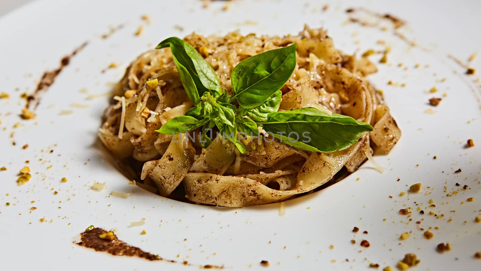 Tagliatelle with mushrooms and decorated with basil leaves