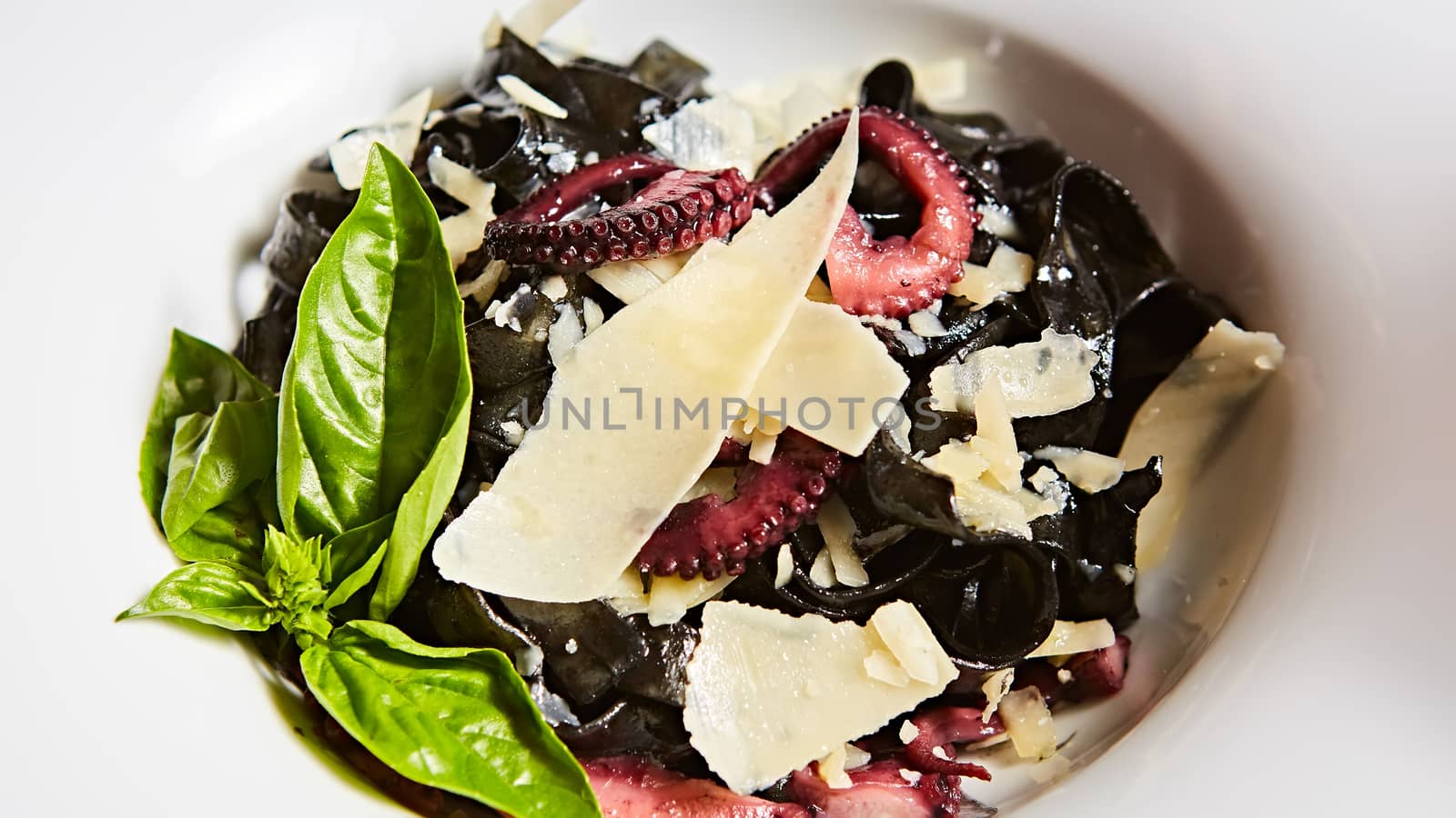 Pasta with black cuttlefish ink, octopuses and parmesan