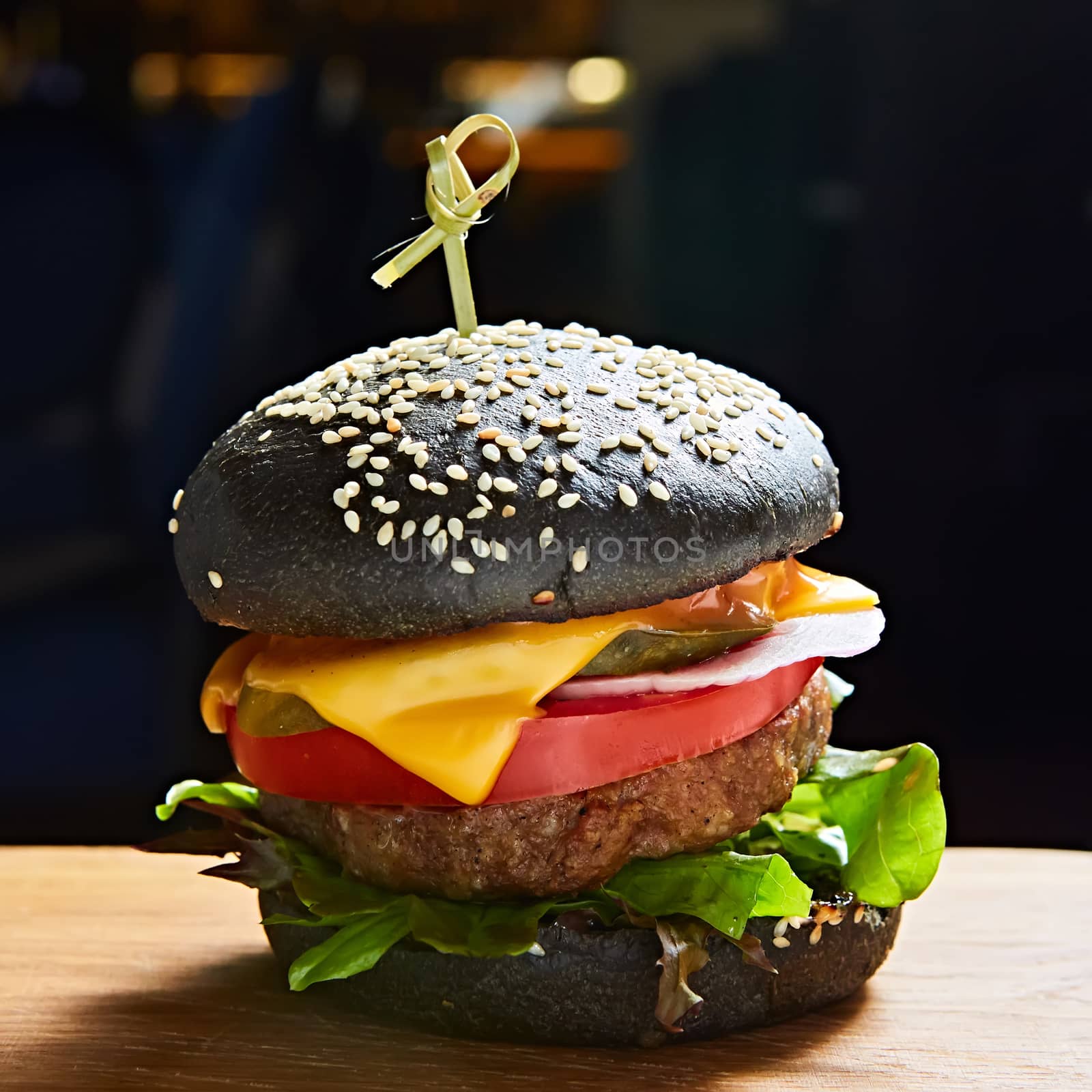 Japanese Black Burger with Cheese. Cheeseburger from Japan with black bun on dark background