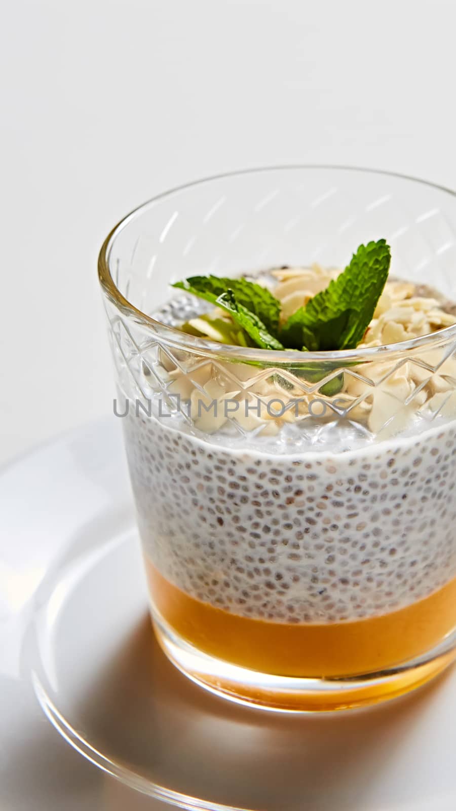 Mango yogurt with chia seeds for healthy brekfast on a white background, copy space