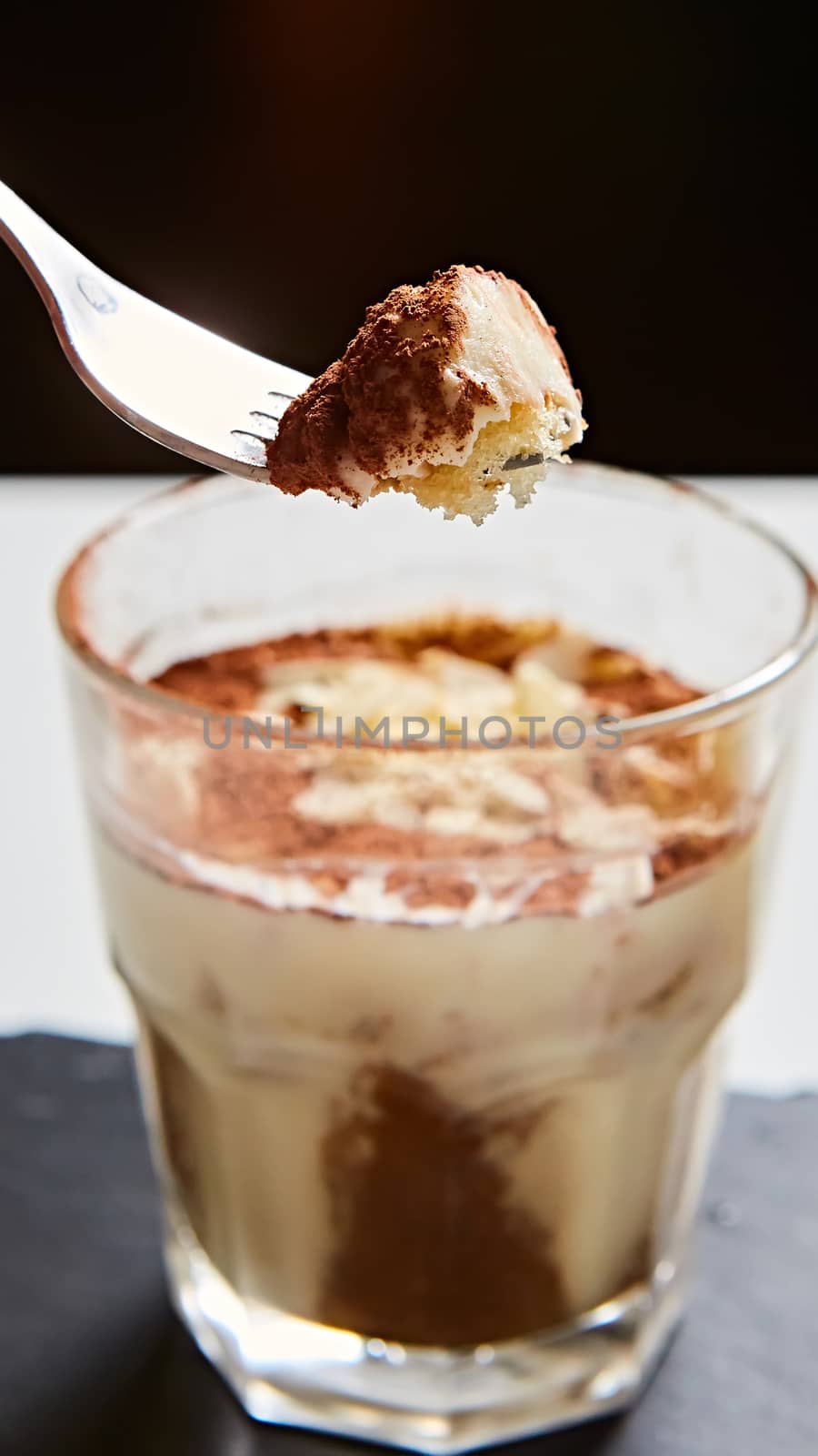 Tiramisu in glass, traditional coffee flavored Italian dessert made of ladyfingers and mascarpone
