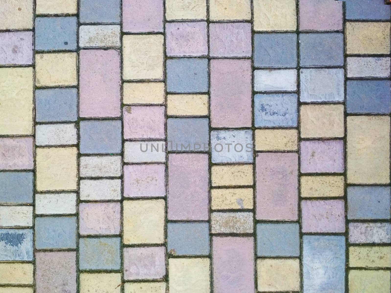 Pavement tiles of different colors and shapes.

Stacked rows of stones of the correct shape of different colors.