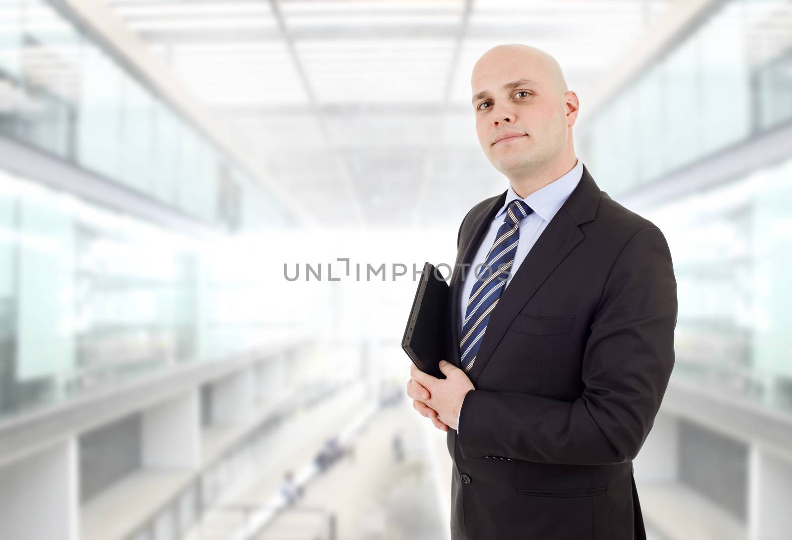 proud businessman with a tablet pc, at the office